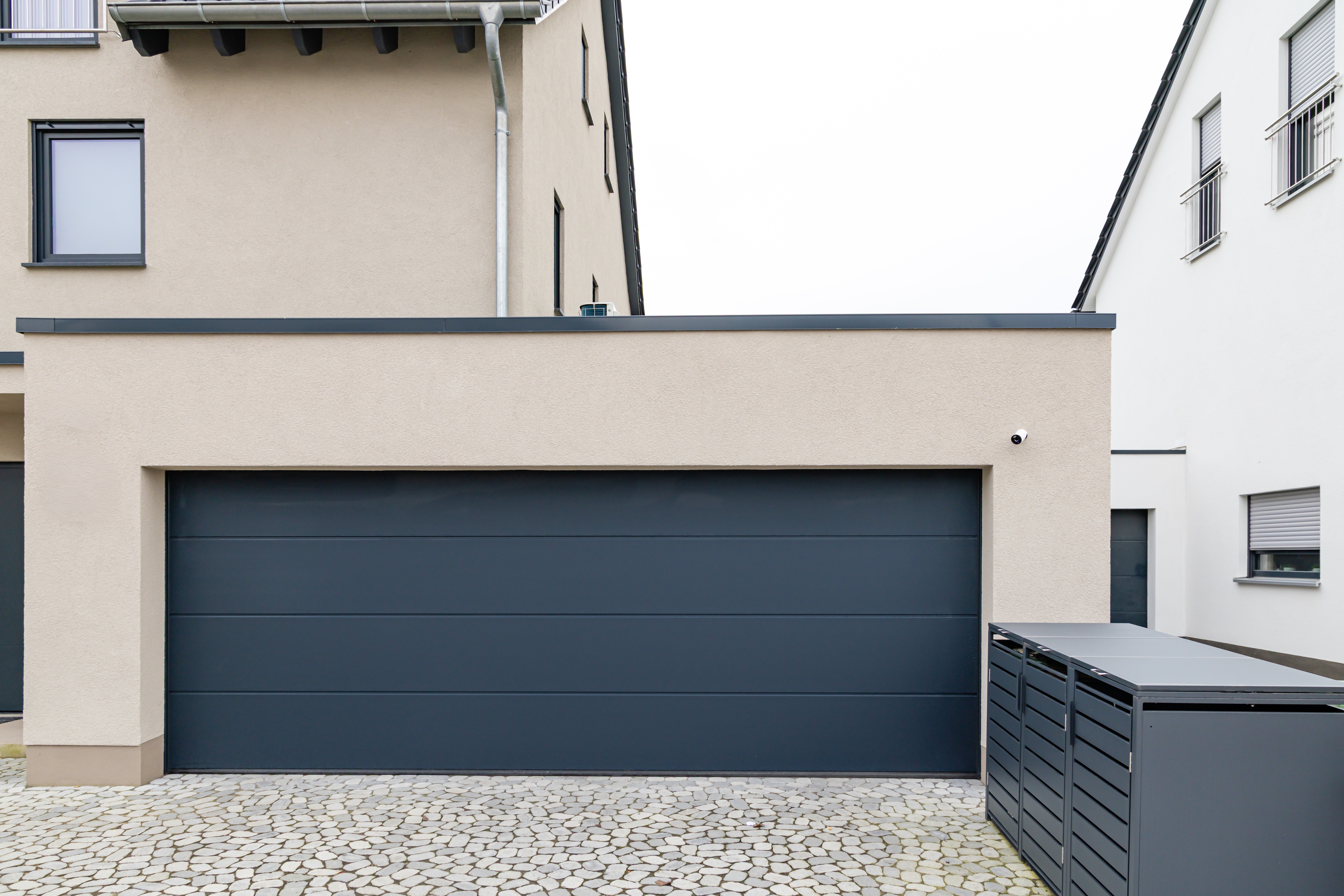 homeowner choosing the right garage door company while discussing options with a technician