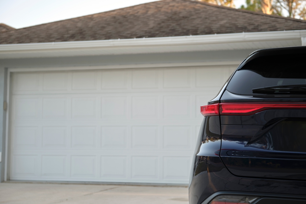 Homeowner checking a garage door that won’t open before calling a professional technician