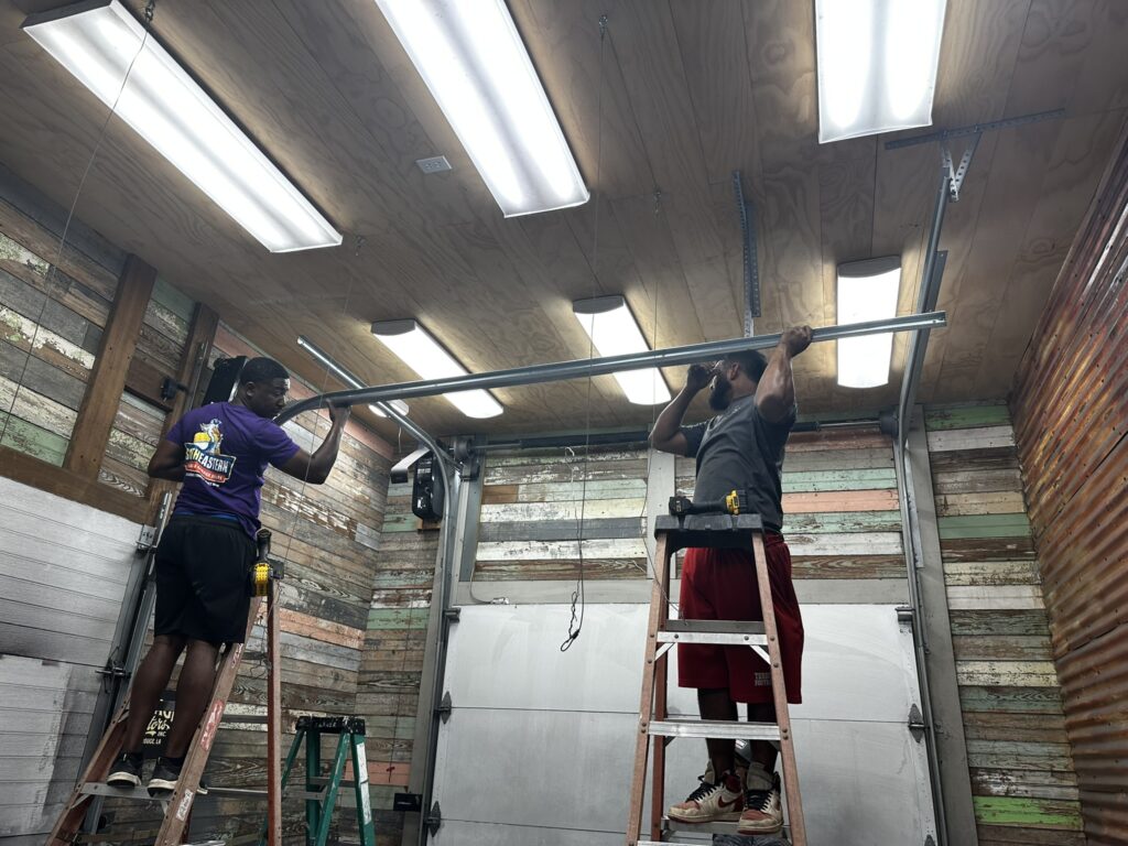Technician inspecting dangerous garage door problems to ensure safe operation and prevent accidents
